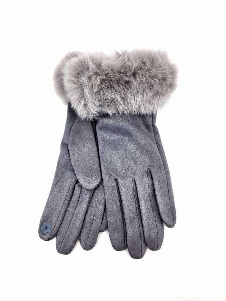 May include: Gray suede gloves with a faux fur cuff. The gloves have a small blue flower embroidered on the thumb.