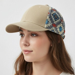 May include: A tan baseball cap with a patterned mesh back. The pattern includes blue, red, and white geometric shapes. The cap has a curved brim and a button on top.