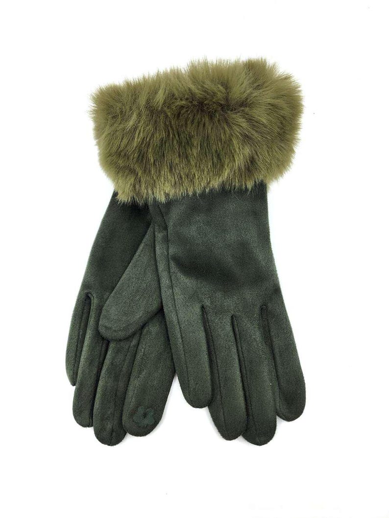 May include: A pair of green suede gloves with a faux fur cuff. The gloves are fingerless and have a textured surface.