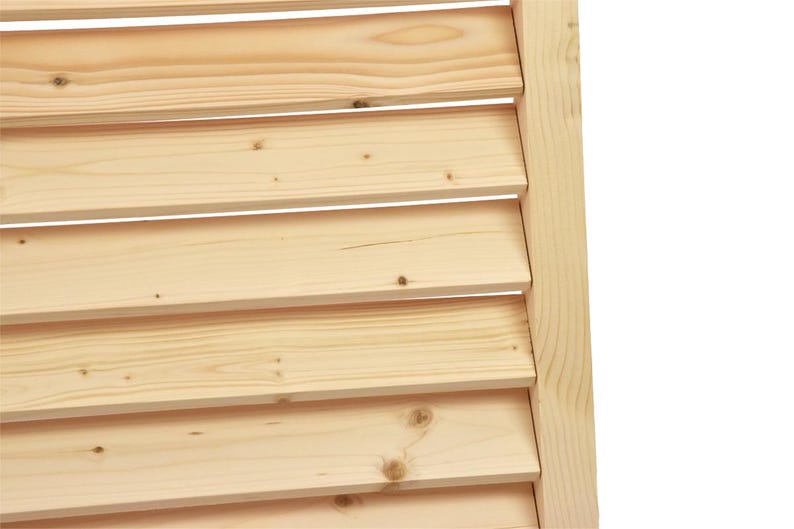 May include: Close-up of a wooden shutter with horizontal slats. The slats are made of light-colored wood and are arranged in a staggered pattern.