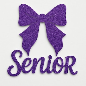 May include: A purple glitter bow with the word "Senior" in a cursive font. The bow is at the top of the image, and the word "Senior" is below it. The background is white.