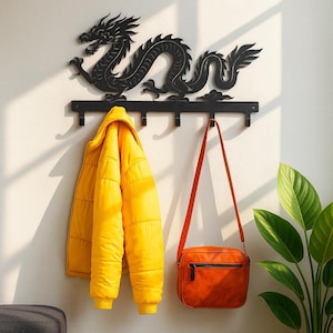 May include: A black metal dragon wall hook with five hooks, holding a yellow puffer jacket and an orange crossbody bag. The dragon design is above the hooks, adding a decorative element to the functional storage.