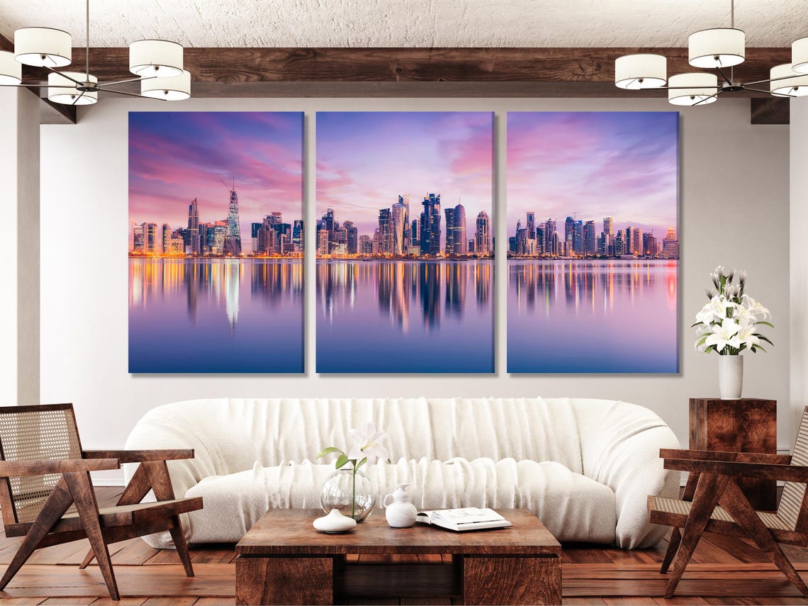 Dusk city skyline with illuminated skyscrapers reflected in calm water detail view