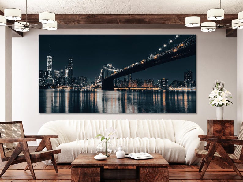 Night cityscape with a brightly lit bridge spanning dark water and a glowing skyline