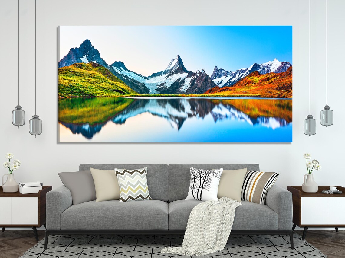Living room mockup with multiple vertical panels showing a mountain sunrise landscape above a sofa