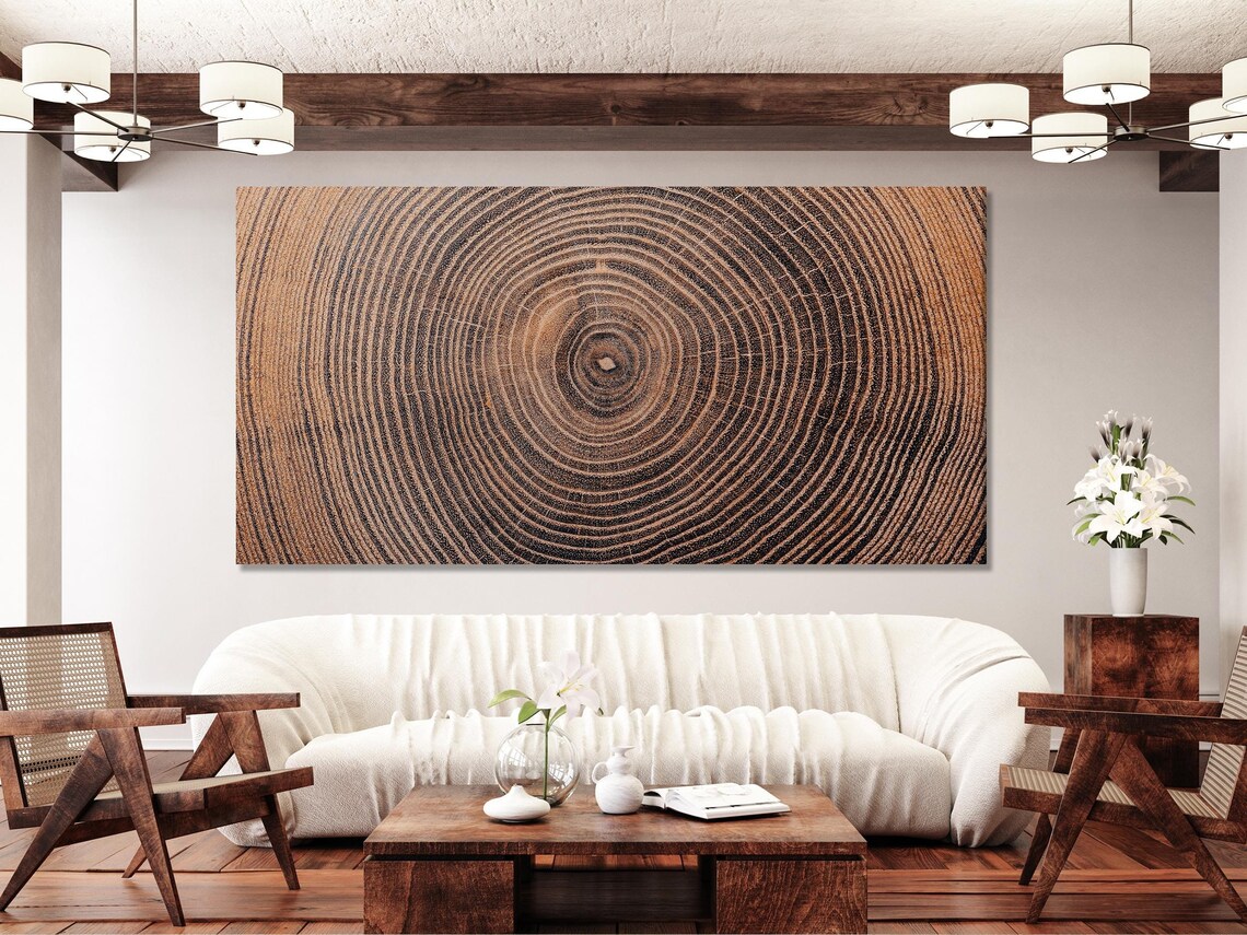 Three square panels show concentric tree-ring patterns radiating from darker centres, set within textured wood-grain lines in warm browns and black