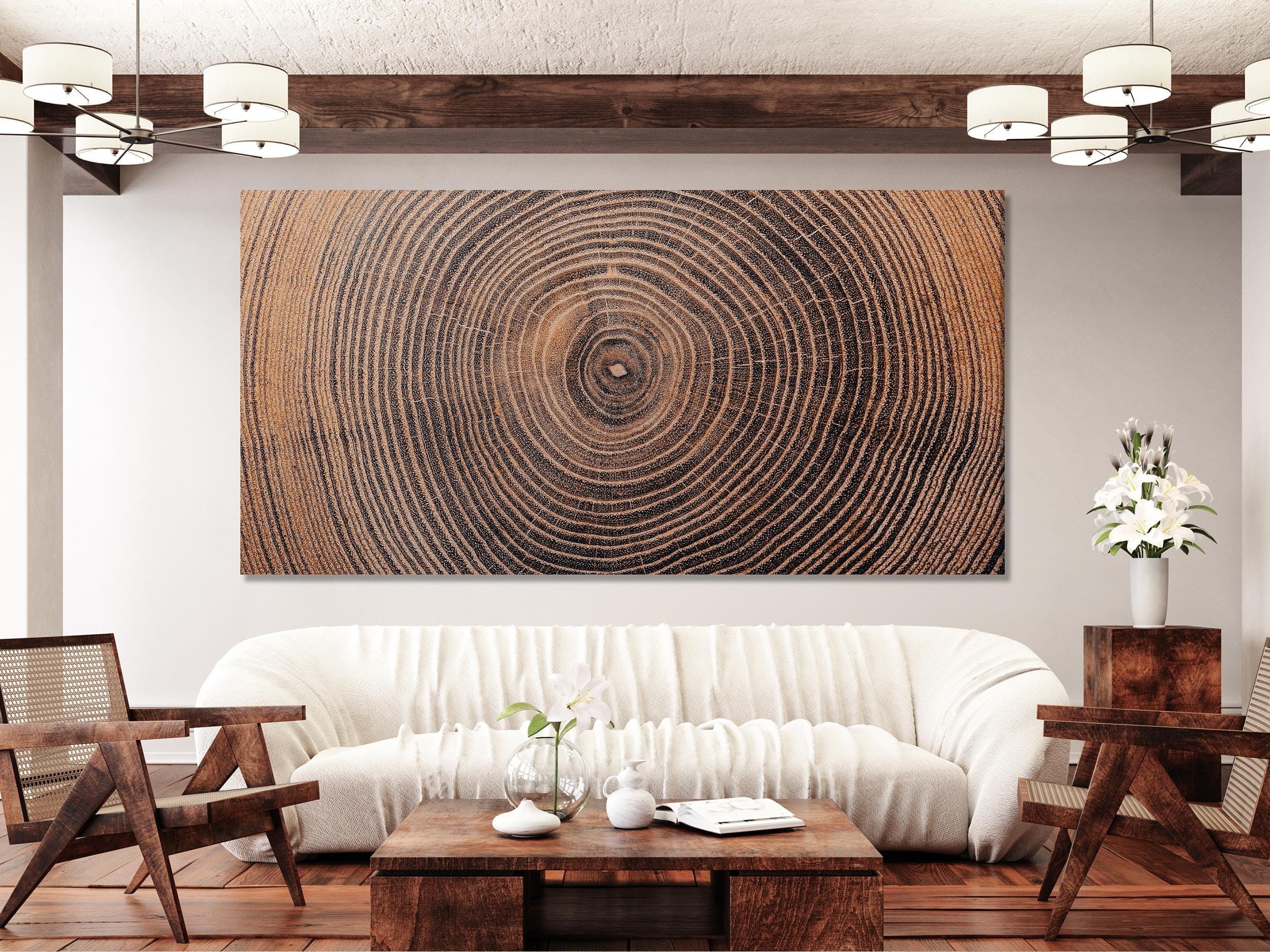Three square panels show concentric tree-ring patterns radiating from darker centres, set within textured wood-grain lines in warm browns and black