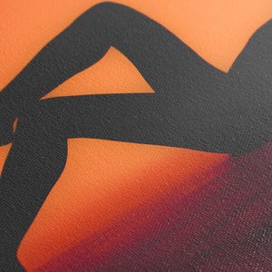 Canvas print featuring a stylized silhouette of a person's legs against a vibrant orange-to-burgundy gradient background. The silhouette is dark charcoal gray, providing a striking contrast to the warm hues of the backdrop. The texture of the canvas is subtly visible, adding depth to the artwork.  The image is a modern, abstract depiction, suitable for contemporary home decor or art collections. The artwork uses a bold color palette and simple lines to create a visually appealing piece.