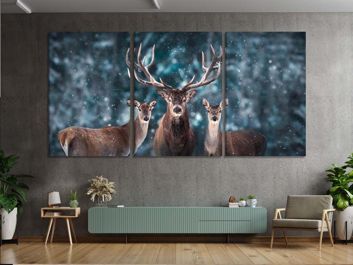 Room mockup with a landscape artwork of three deer in a snowy blue forest