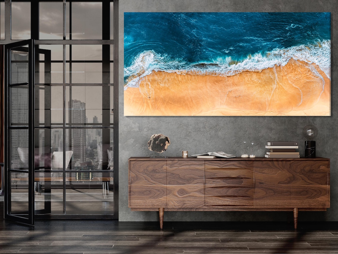 Seascape wall mockup showing five vertical ocean wave artworks above a kitchen table with chairs