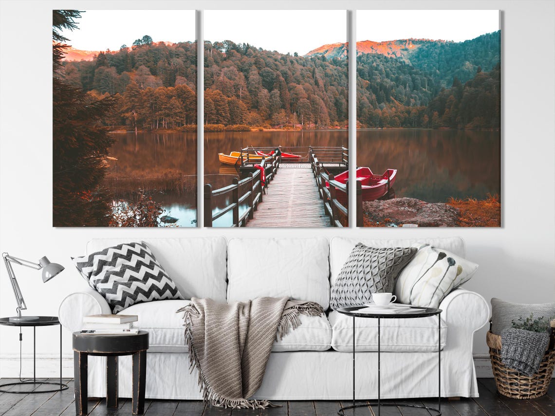 Room mockup with large autumn lake triptych wall art above a sofa