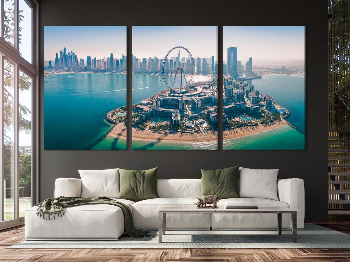 Aerial city skyline over turquoise harbour water with a large Ferris wheel on a foreground island detail view