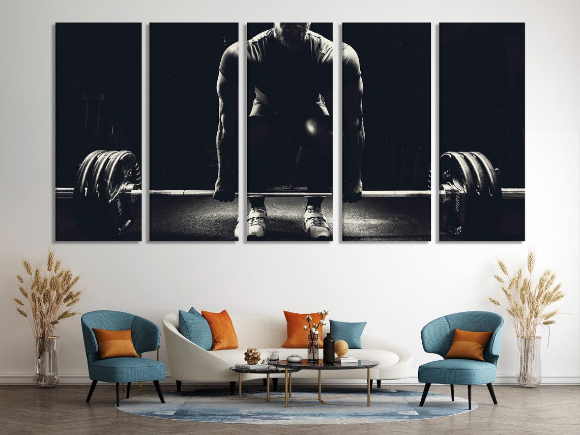 A living room scene with a large black and white weightlifting artwork above a sofa