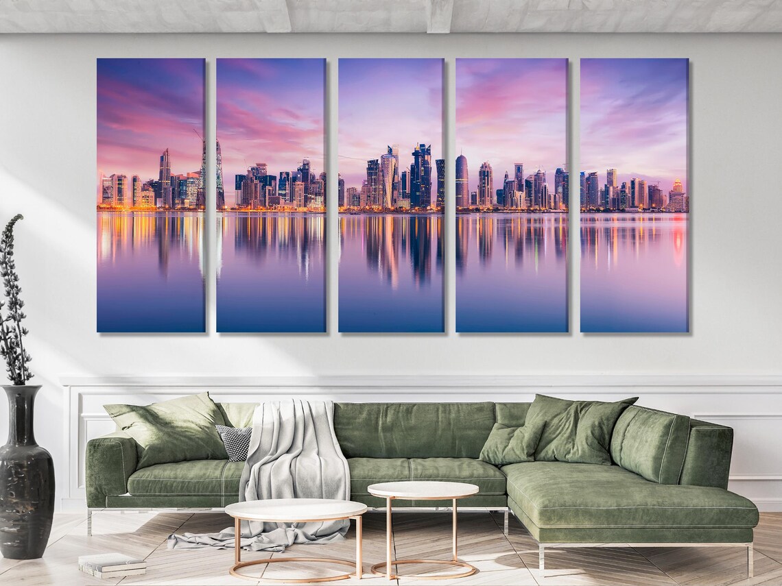 Dusk city skyline with illuminated skyscrapers reflected in calm water detail view