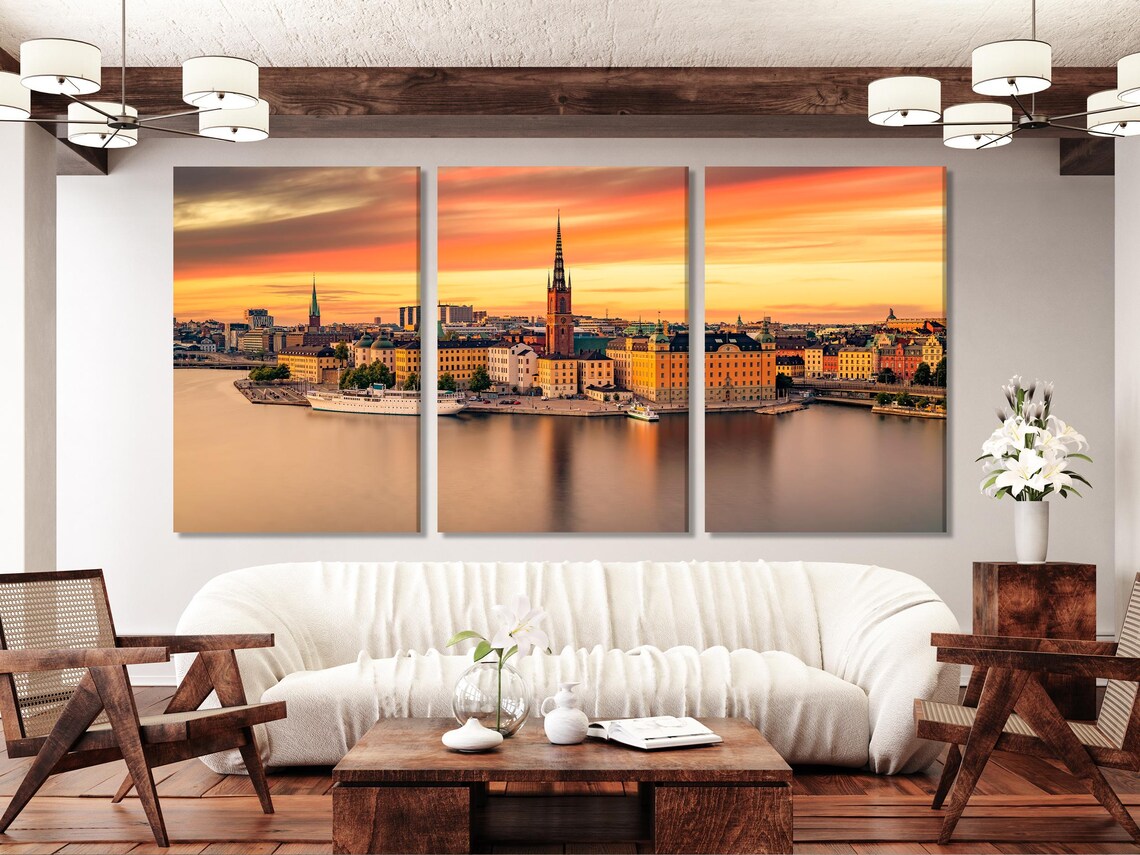 Warm sunset cityscape skyline with spired towers and reflections in calm water detail view