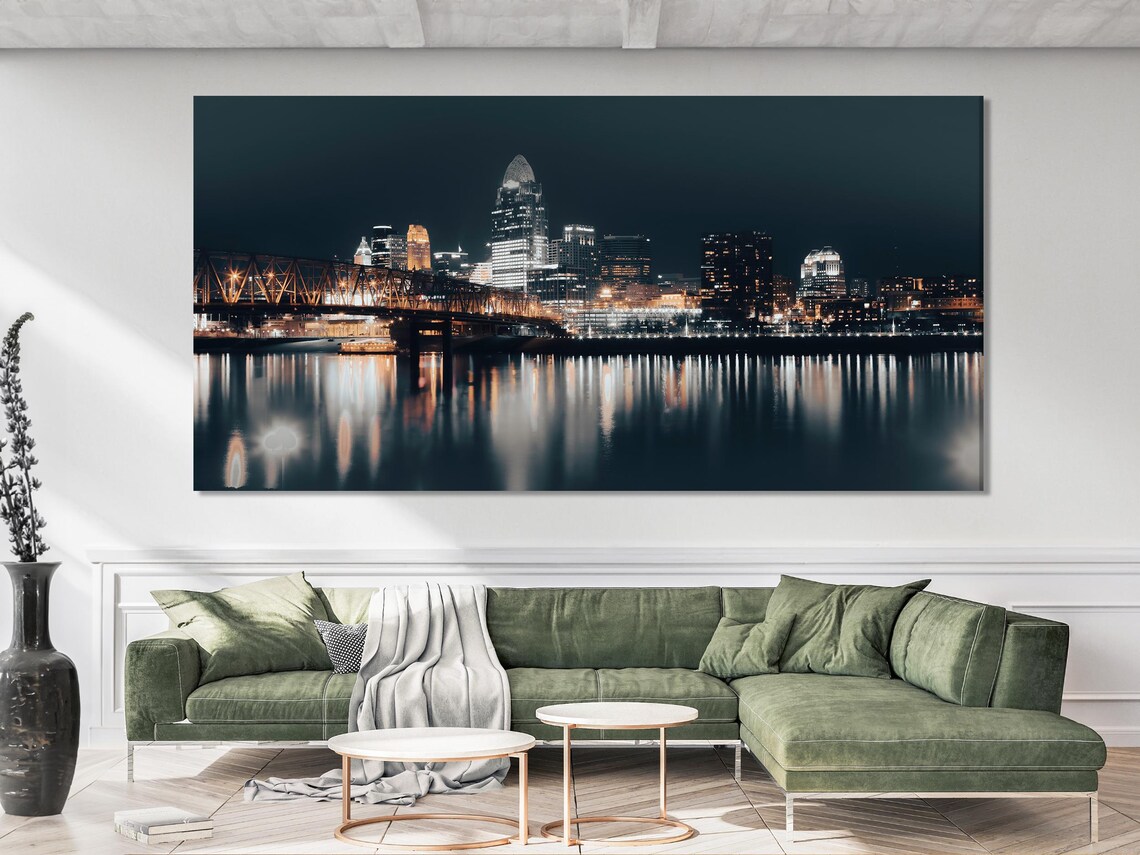 Modern dining room with three-panel night city skyline wall art above a table