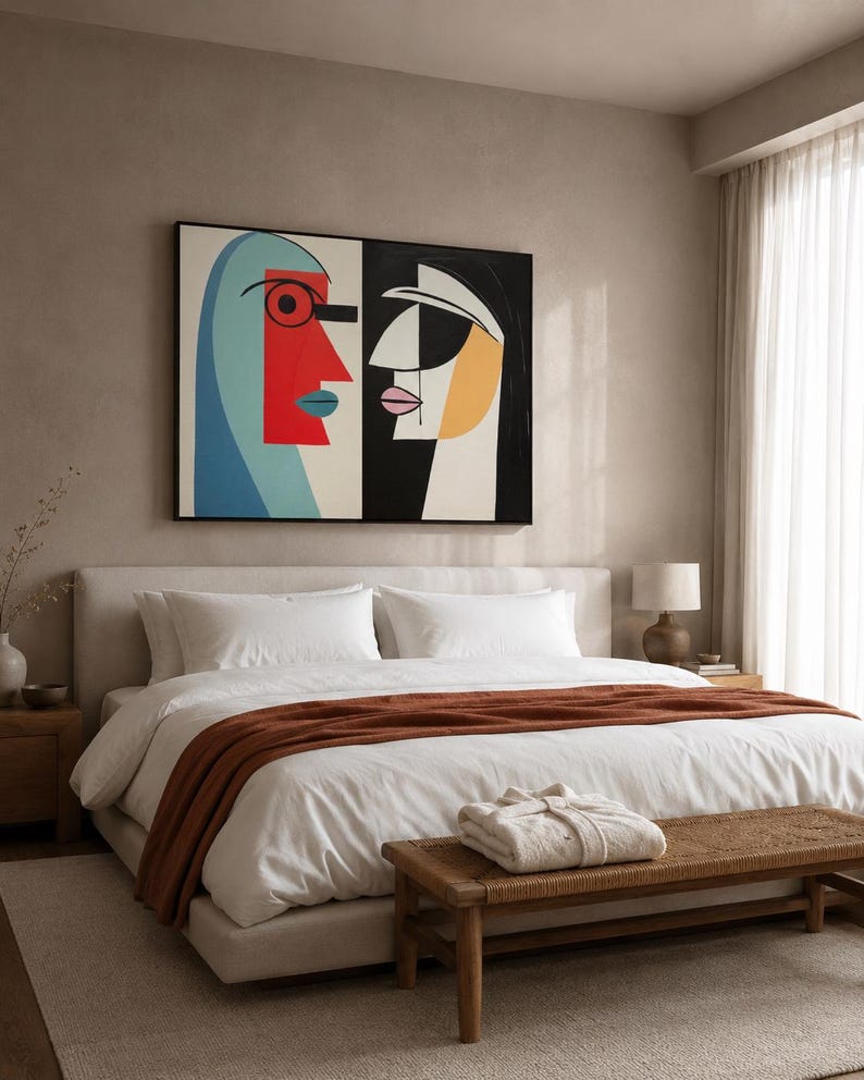 A geometric, cubist-style couple of abstract faces sits within a two-panel composition, using bold red, teal, black and white with warm ochre accents