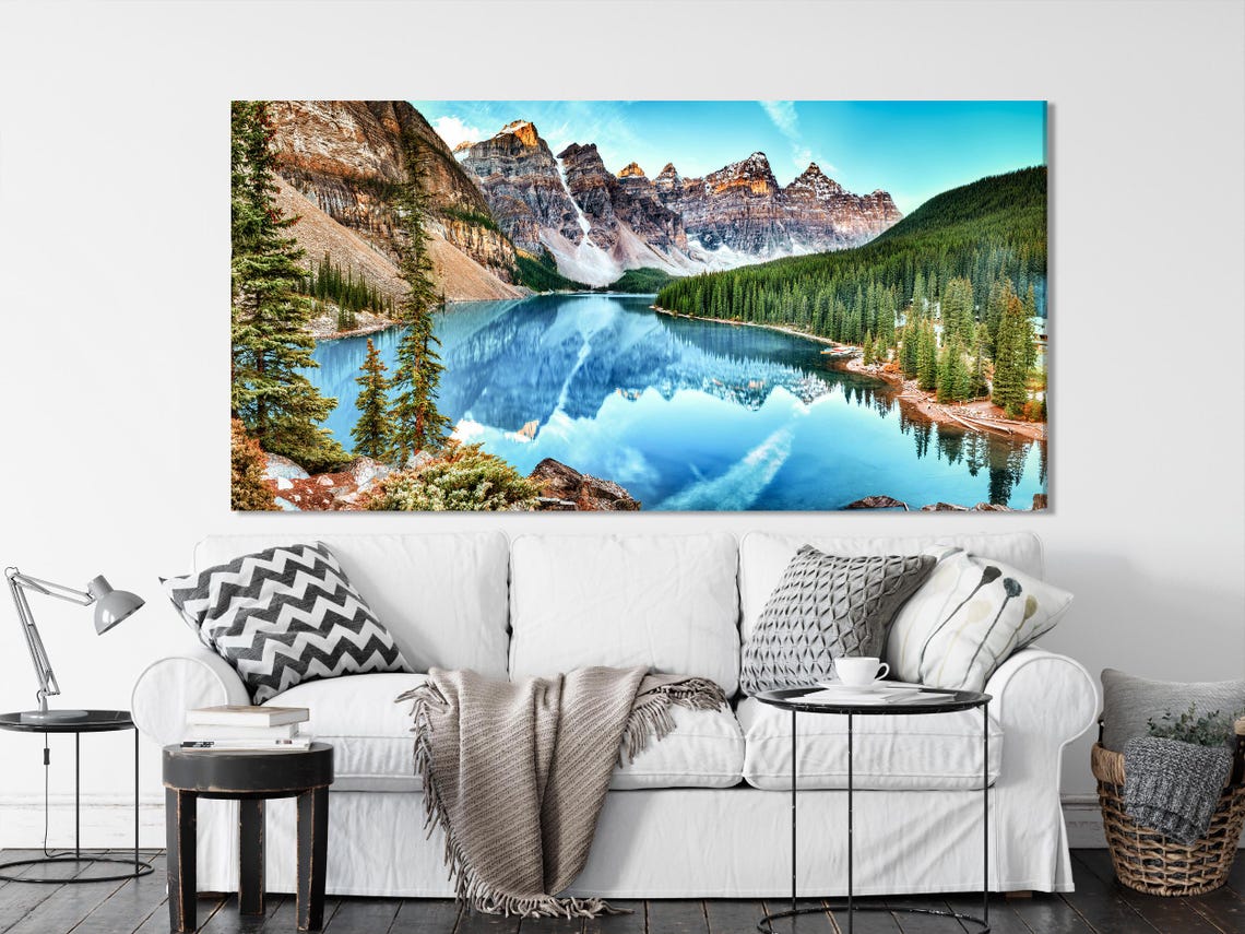 Room mockup showing multi-panel mountain lake landscape above a sofa