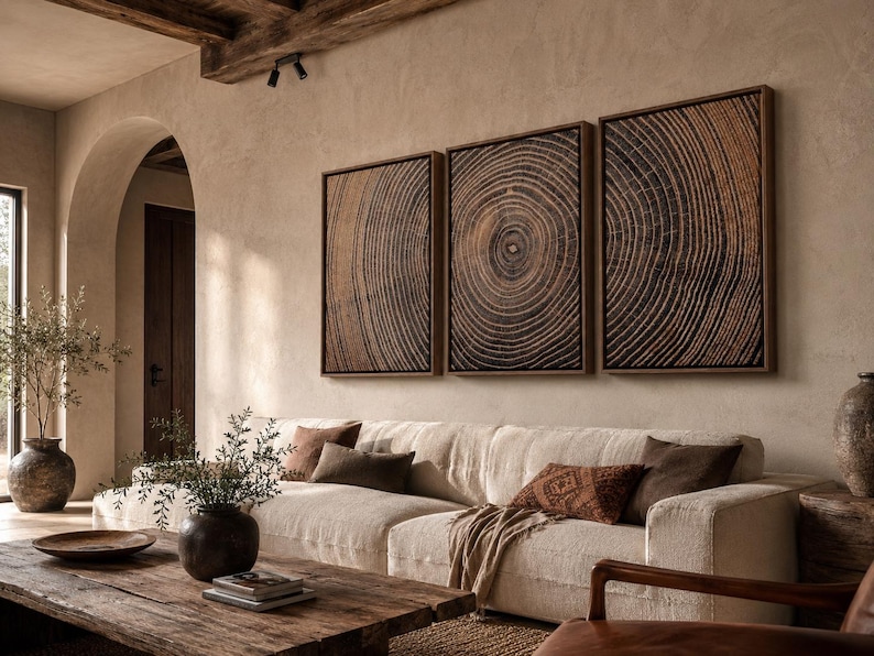 A set of three rectangular wall art pieces featuring a detailed dark brown and black wood grain cross-section pattern, each framed in a thin wooden border, displayed horizontally in a row on a textured beige wall.