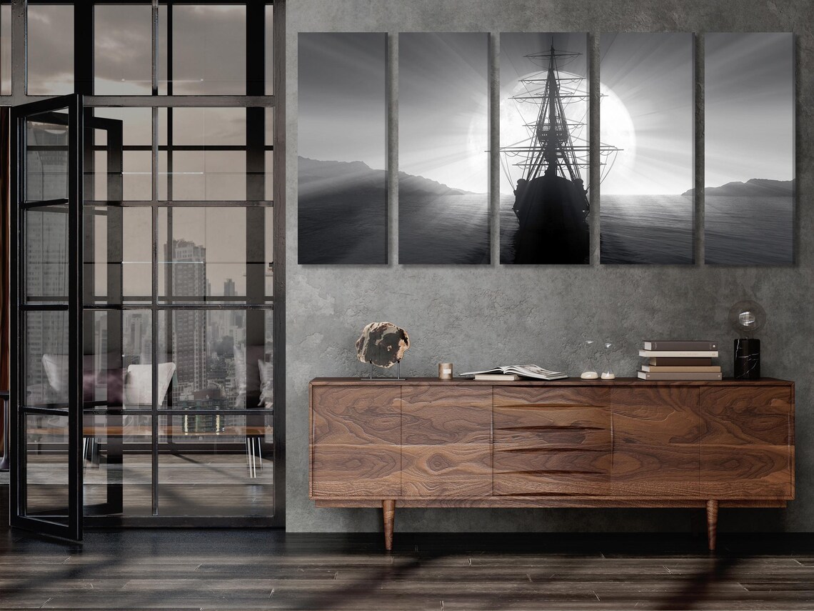 Room mockup with three black-and-white nautical panels above a dining table