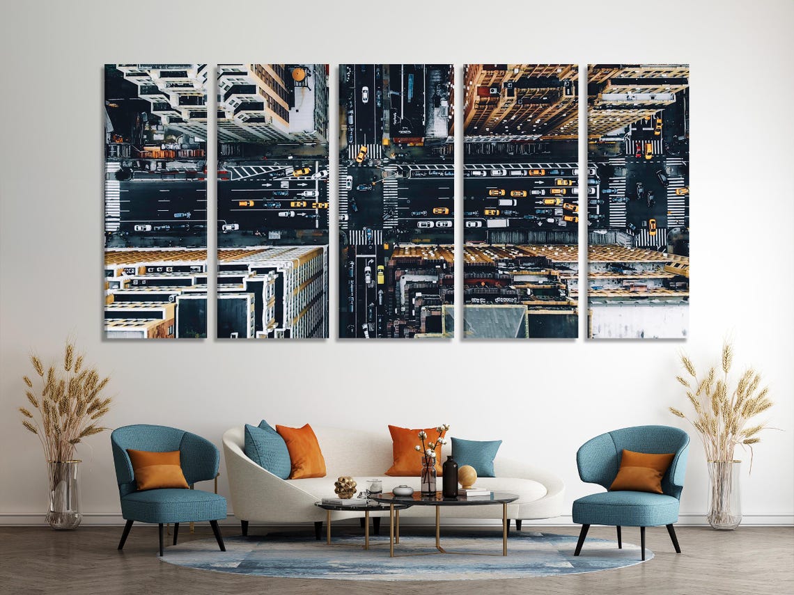 City intersection wall art above a white sofa in a bright living room