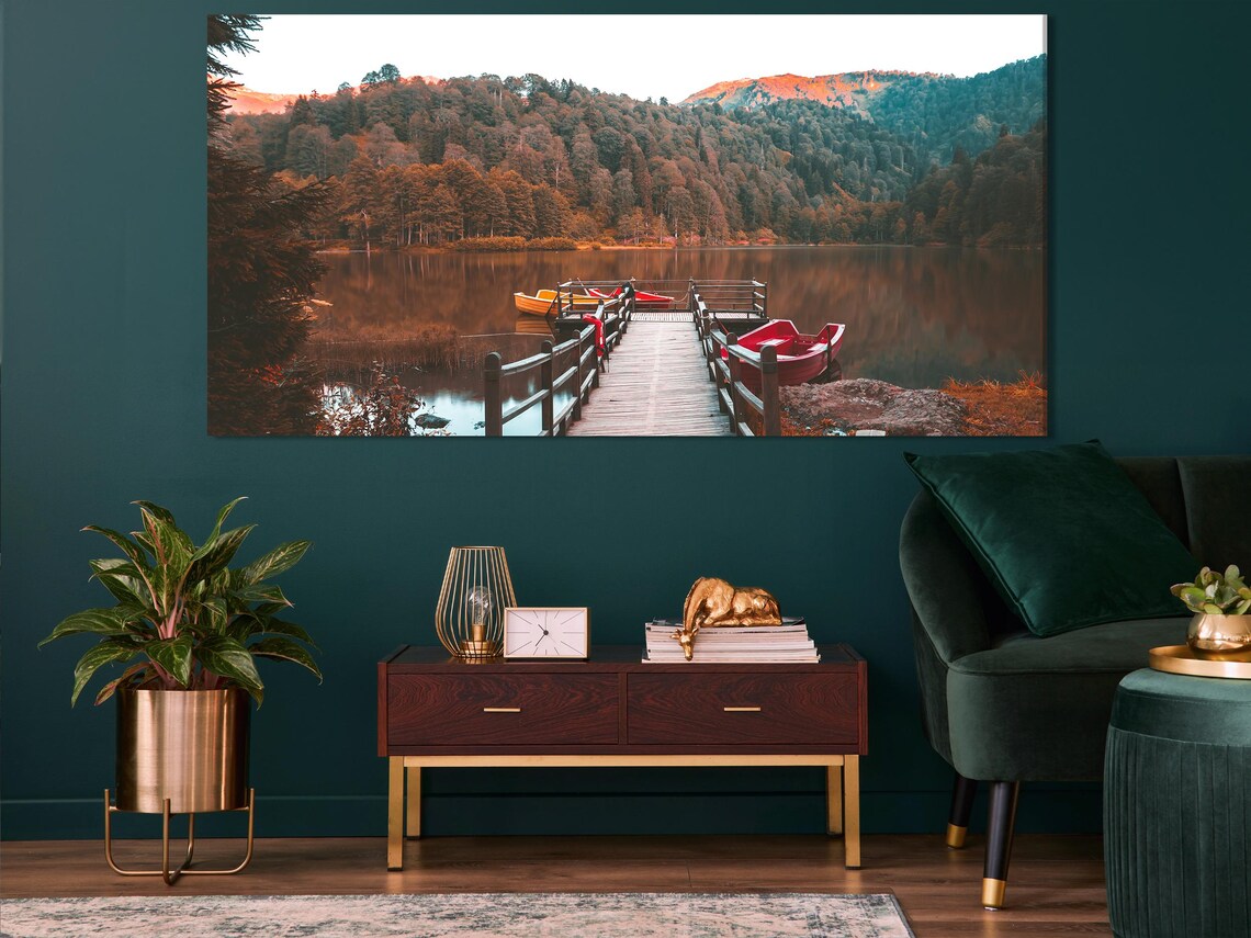Room mockup with large autumn lake triptych wall art above a sofa