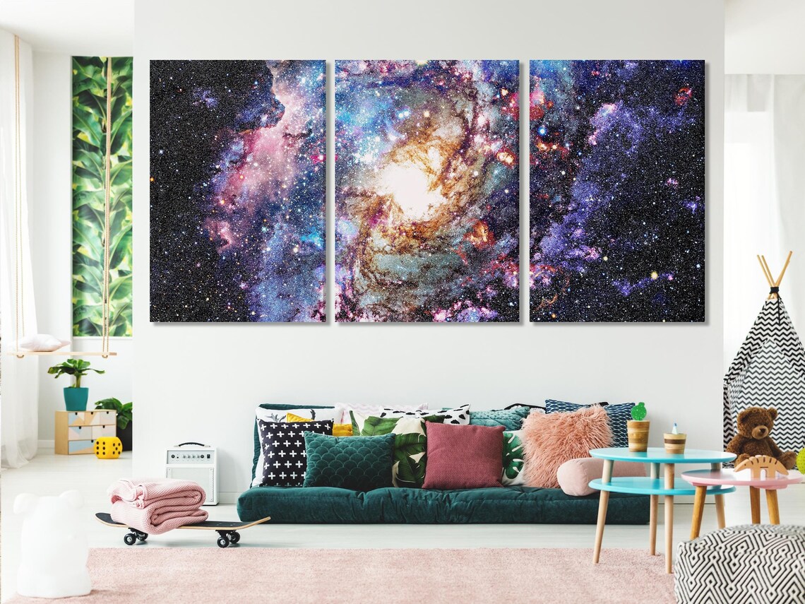 A star-filled nebula scene swirls in deep black space, with bright white cores and colourful purple, blue, pink and orange clouds across the detail