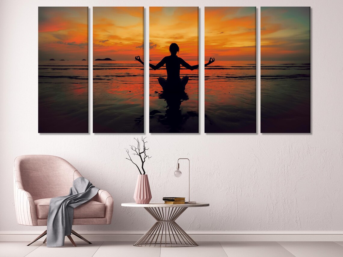 Room mockup with a three-panel sunset meditation artwork on a grey wall above a sofa area