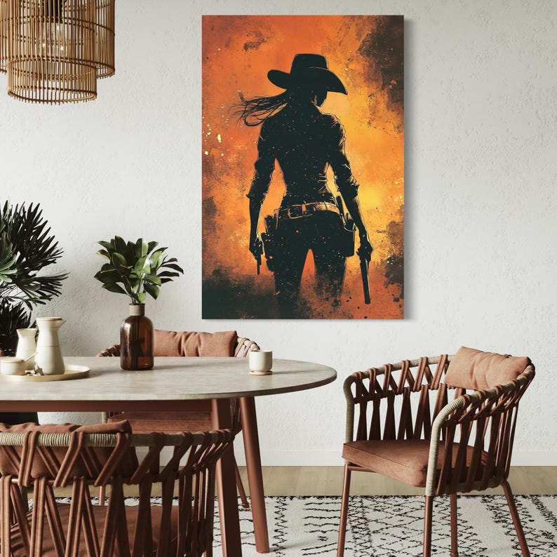 A dark, silhouetted western cowgirl stands with a horse, set against a fiery orange-to-yellow textured backdrop with scattered speckling