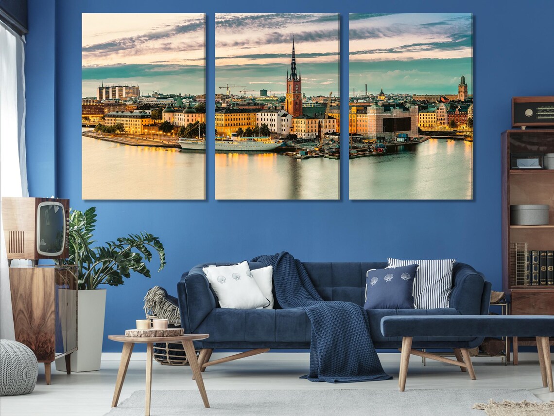Living room scene with a framed sunset cityscape artwork above a sofa