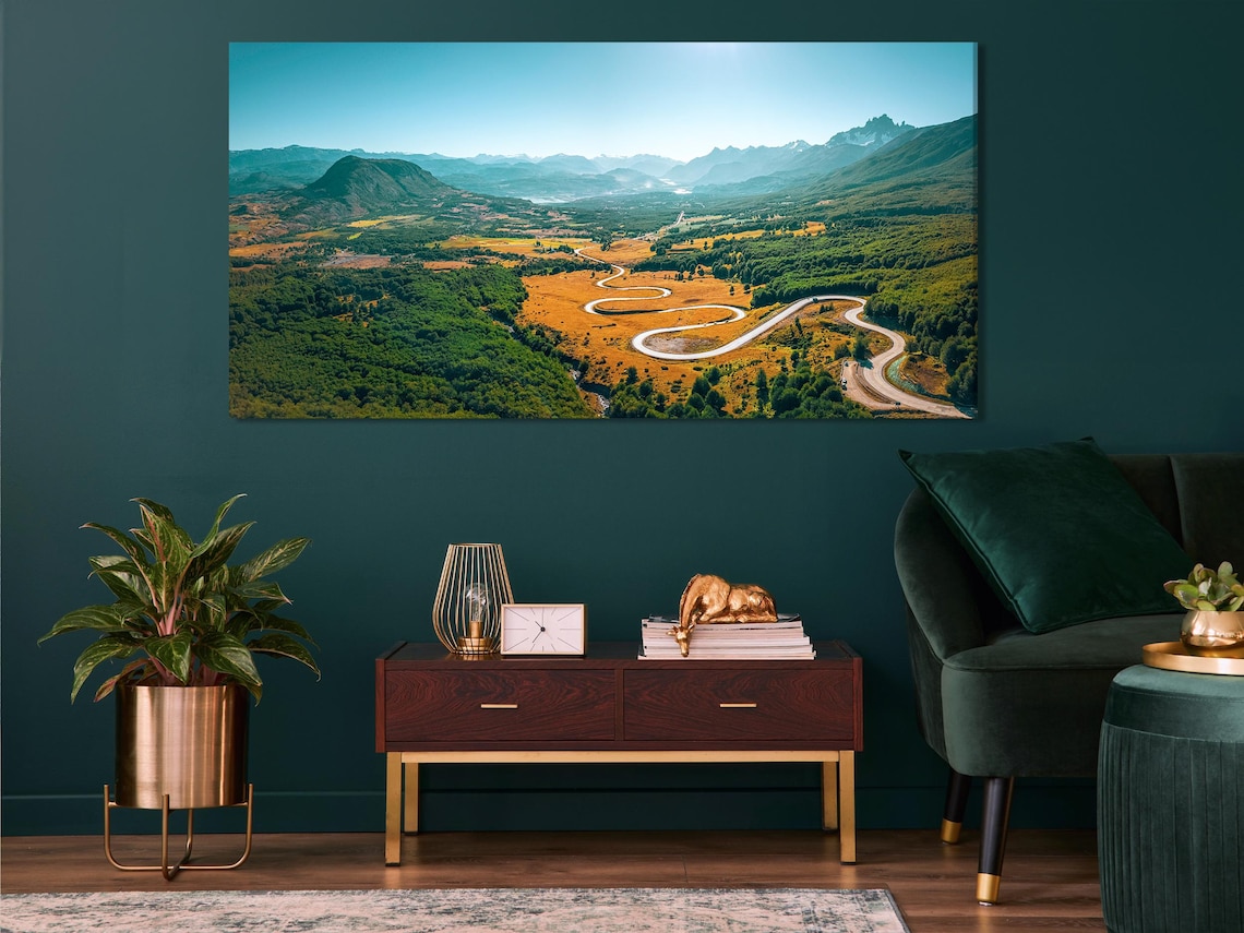 Artwork displayed in a modern living room above a white sofa with cushions and side table