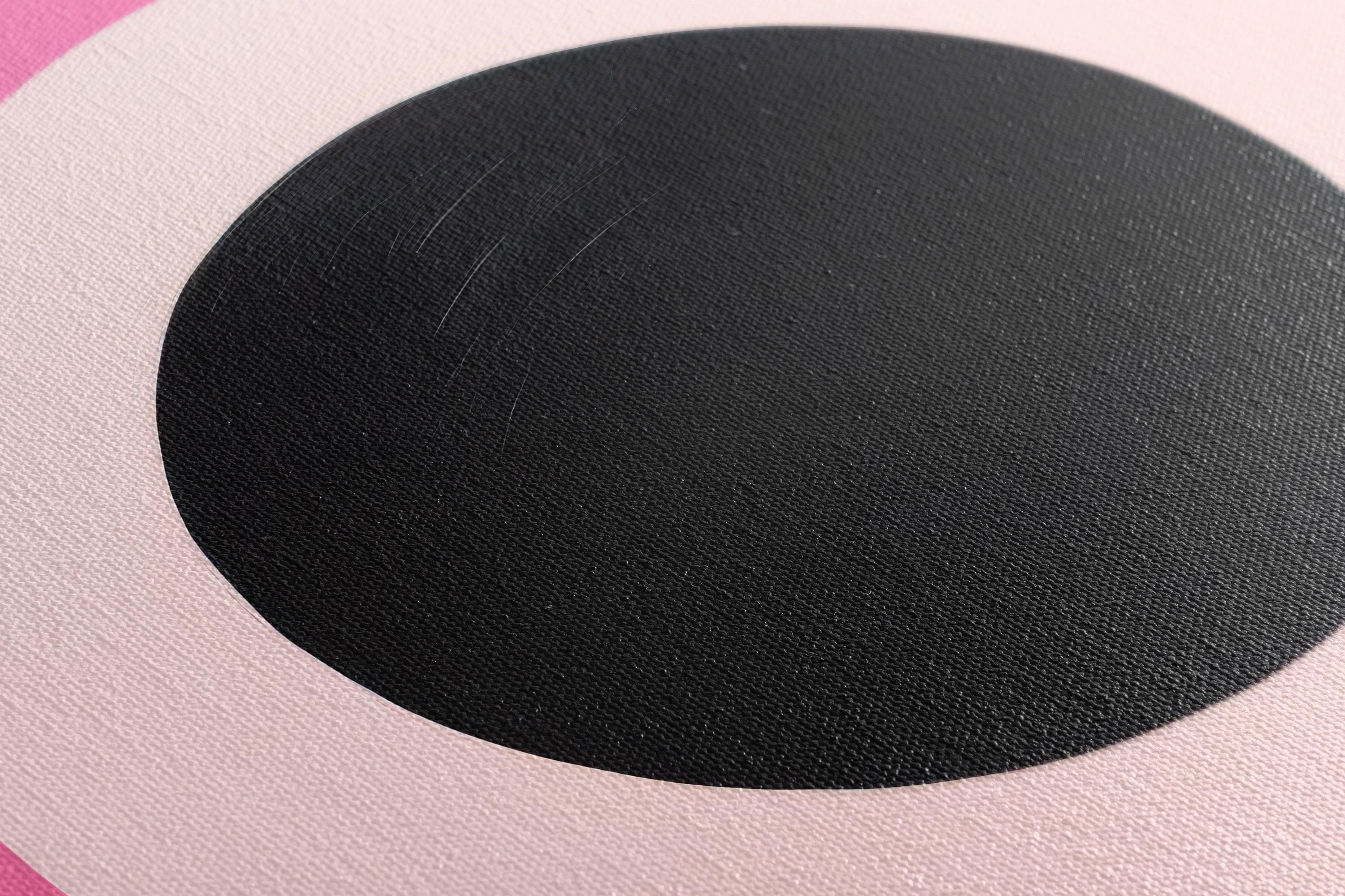 Hot pink and black concentric circles geometric artwork with pale ivory rings detail view
