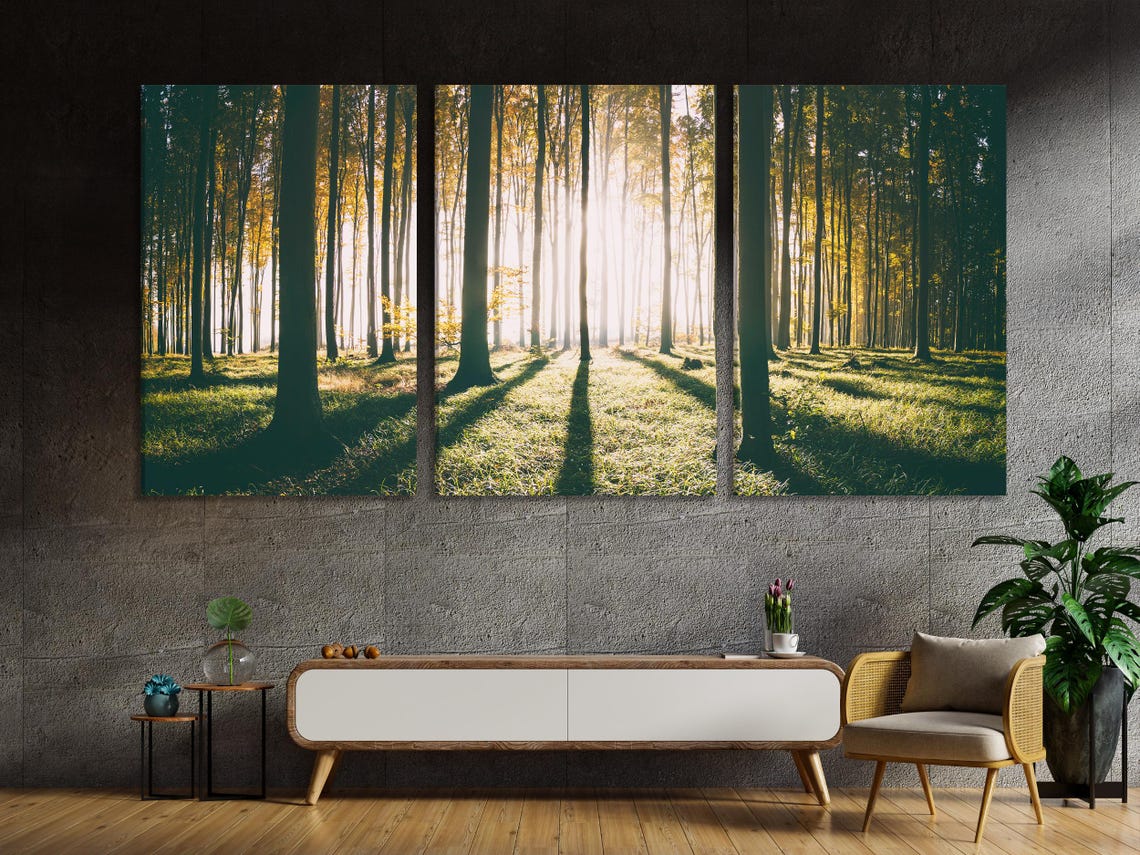 Wooden kitchen interior with a wall of vertical forest tree artworks above the table
