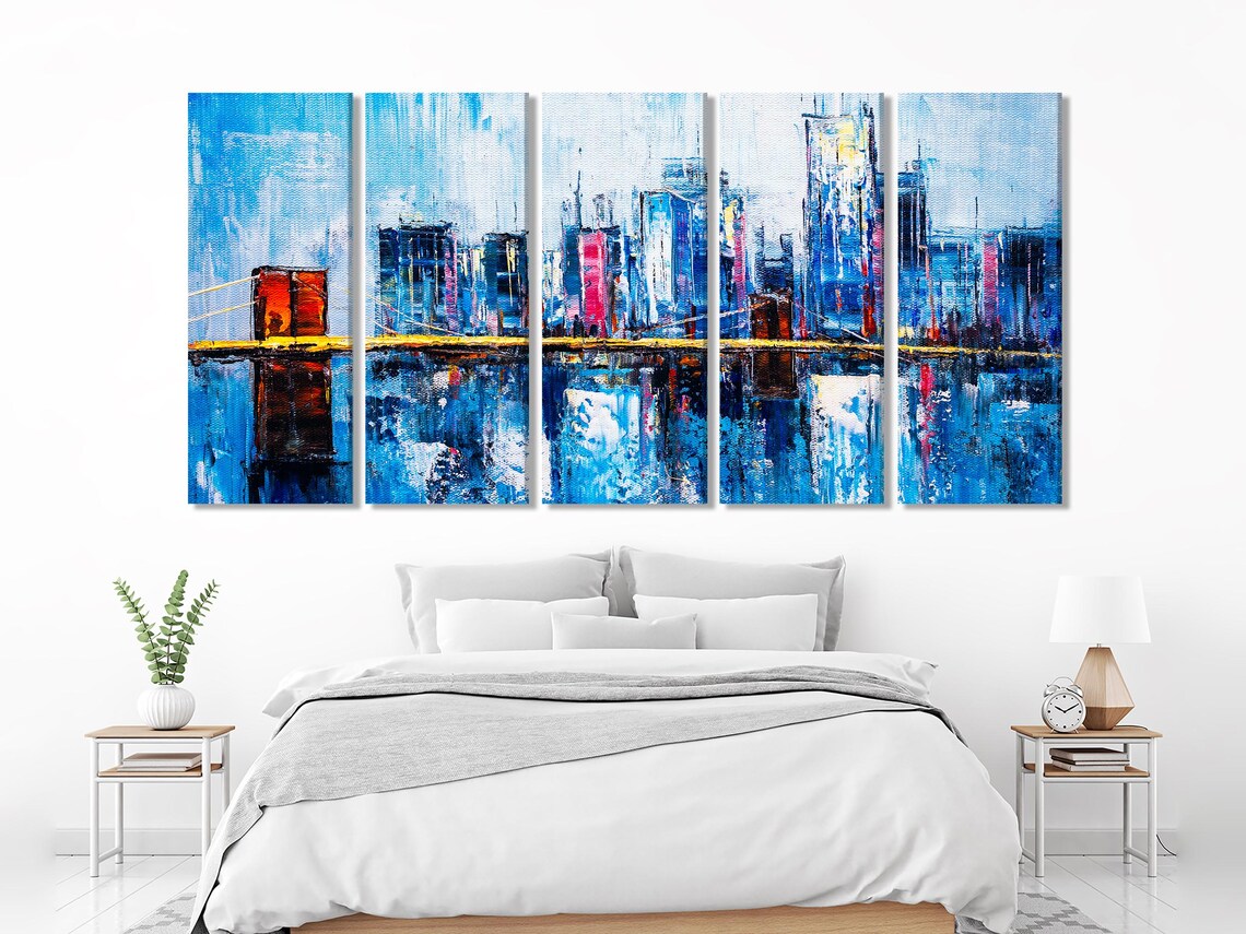 Living room mockup with teal sofa and three-panel blue cityscape wall art above it