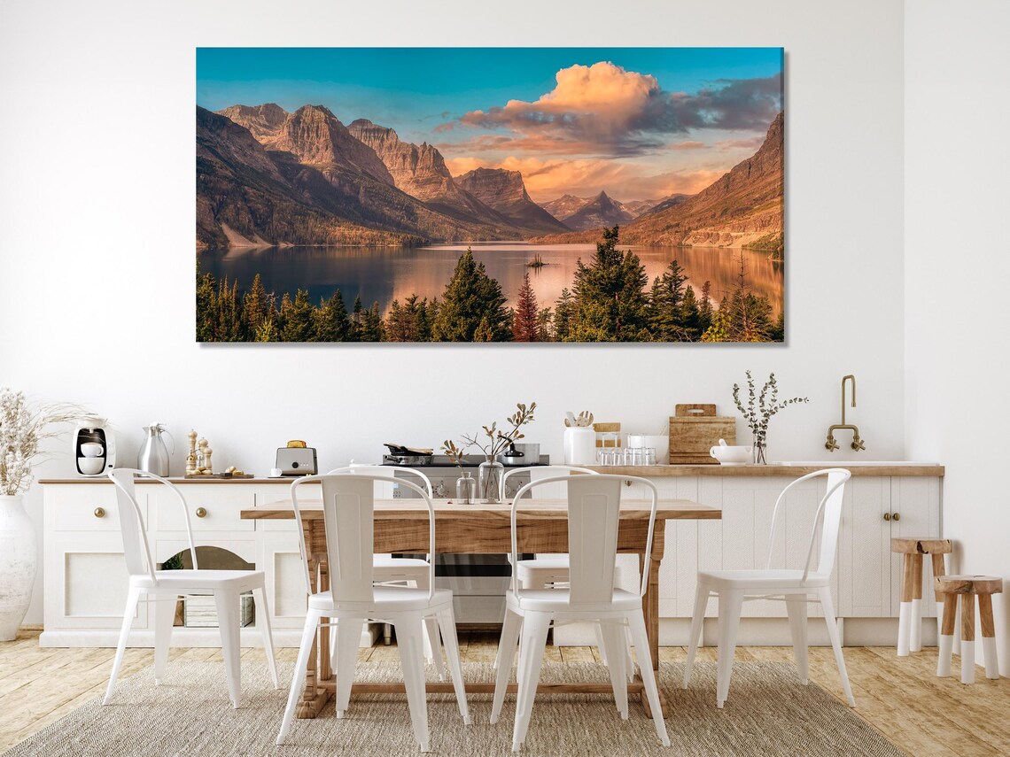 Three-panel landscape artwork with mountains, evergreen trees, calm lake reflections and a sunset sky detail view