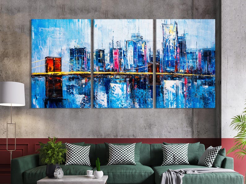 Three-panel blue cityscape skyline with dark silhouettes, red accents and a reflective waterline