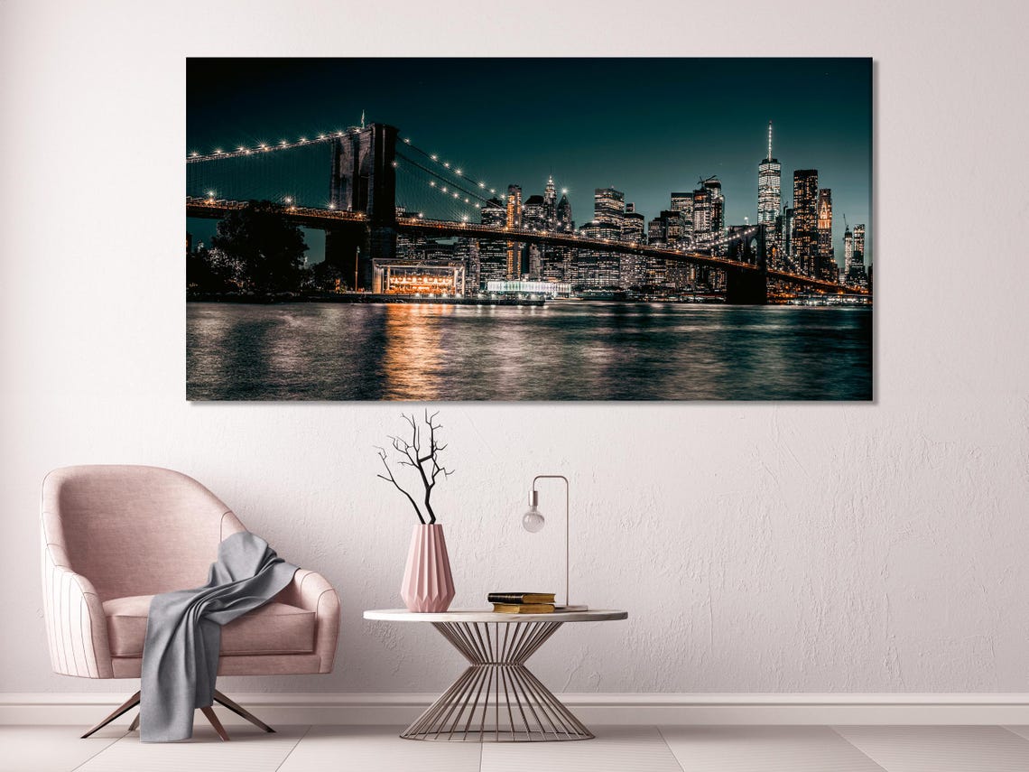 Night cityscape artwork above a white sofa in a modern living room