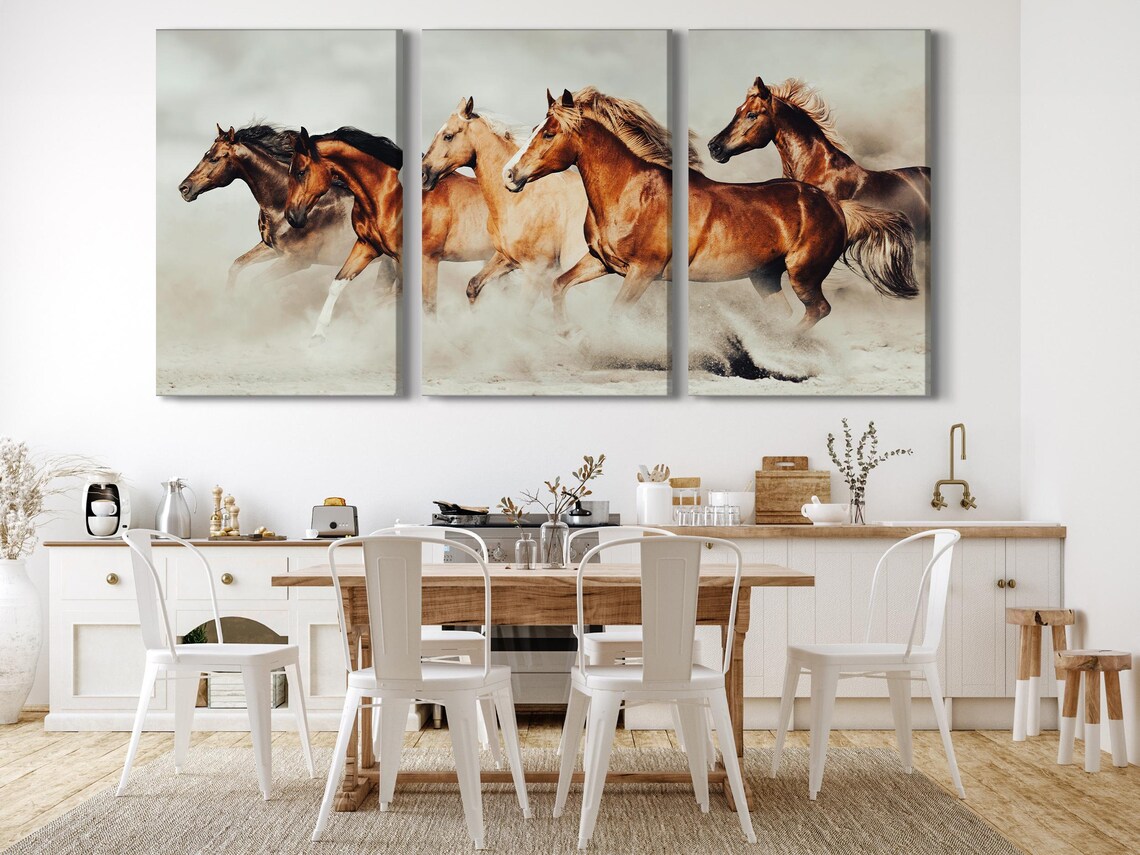 Realistic image of four galloping horses with flowing manes across sandy ground and a hazy pale background detail view