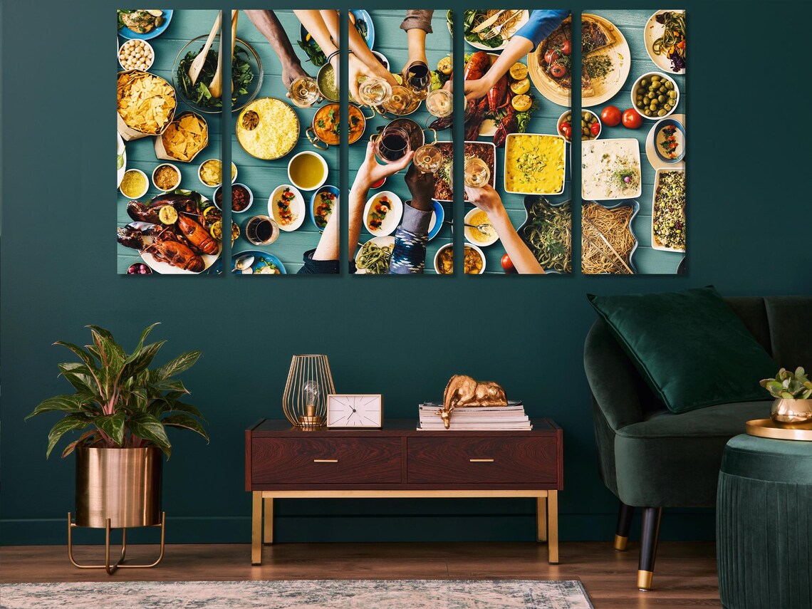 Dining table scene with a wall-hung artwork showing an overhead dinner with wine glasses