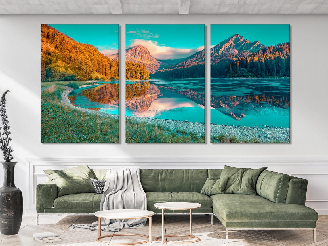 Mountain lake artwork above a sofa in a modern room