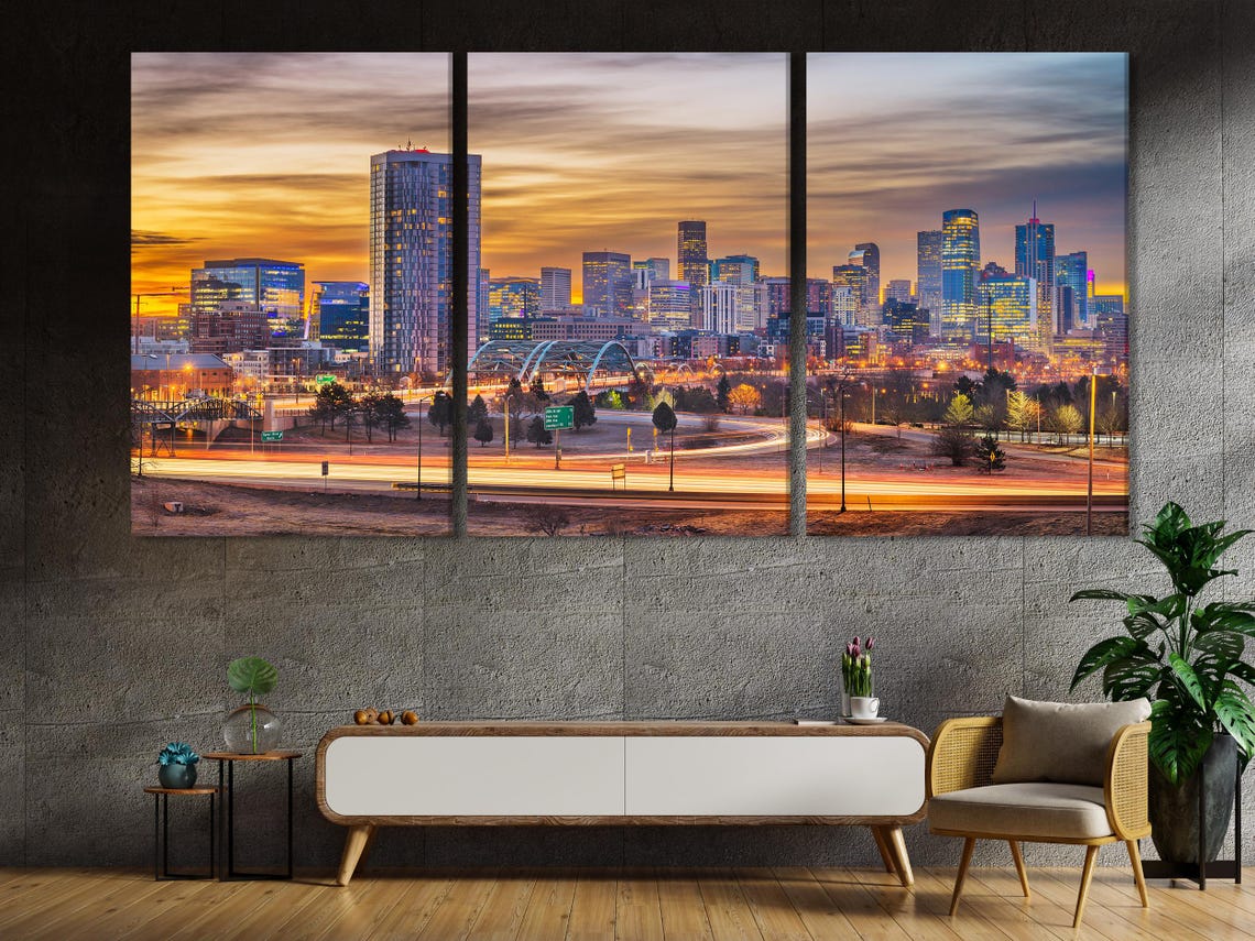 Room mockup showing a large framed city skyline print above a sofa