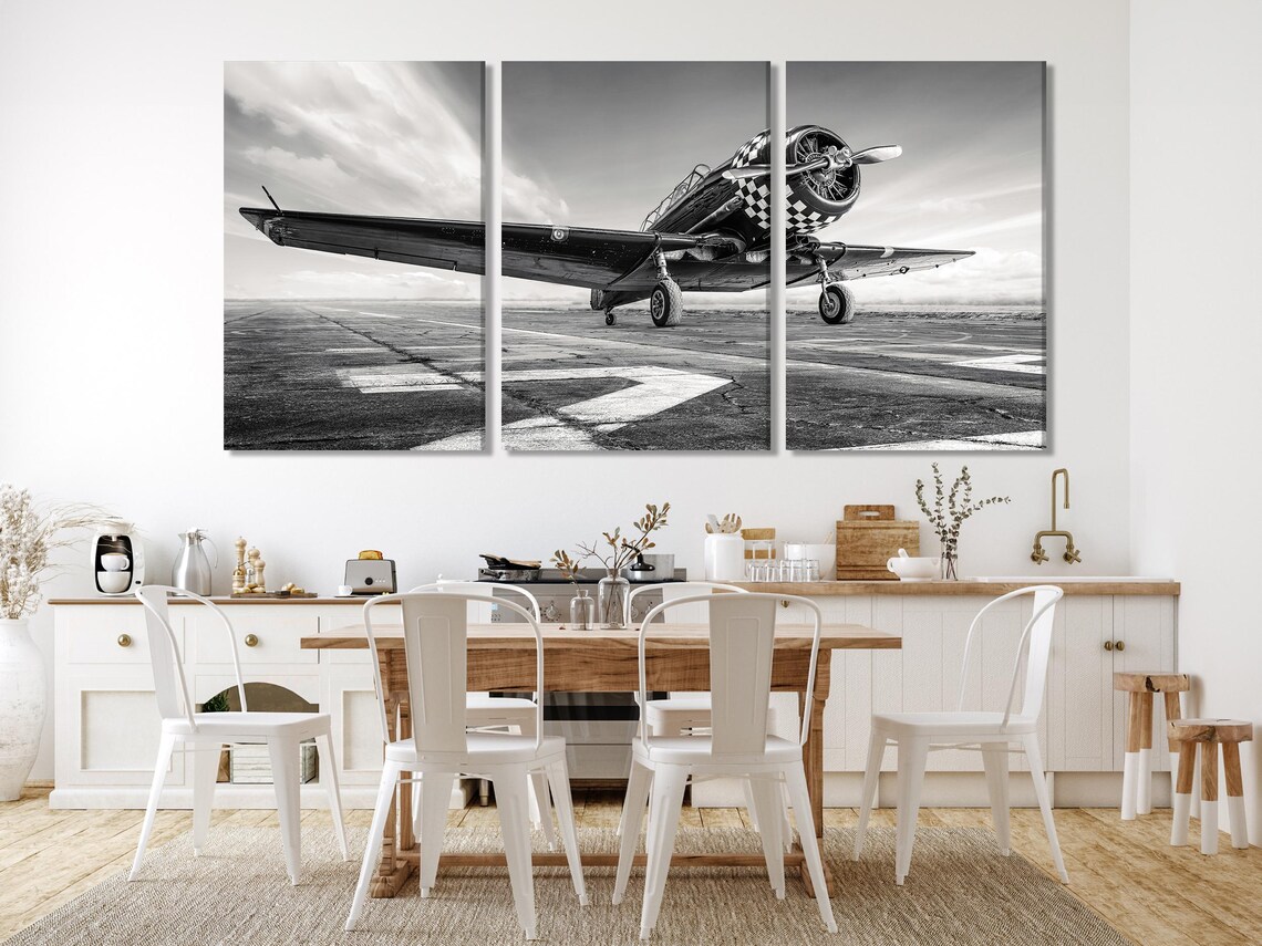 Living room mockup with a wall displaying black and white multi-panel airplane runway artwork above a sofa