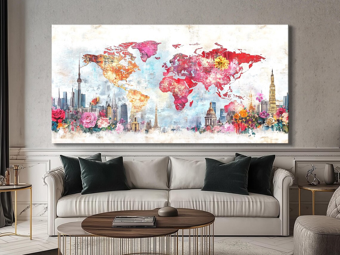 Three framed artworks showing a world map with city skyline and flowers in a modern living room