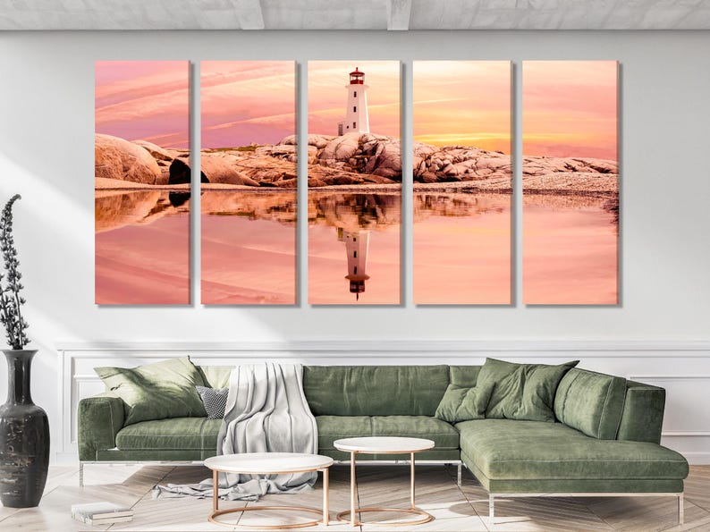 Sunset seascape with a white lighthouse and red roof on rocky shore, reflected in calm water