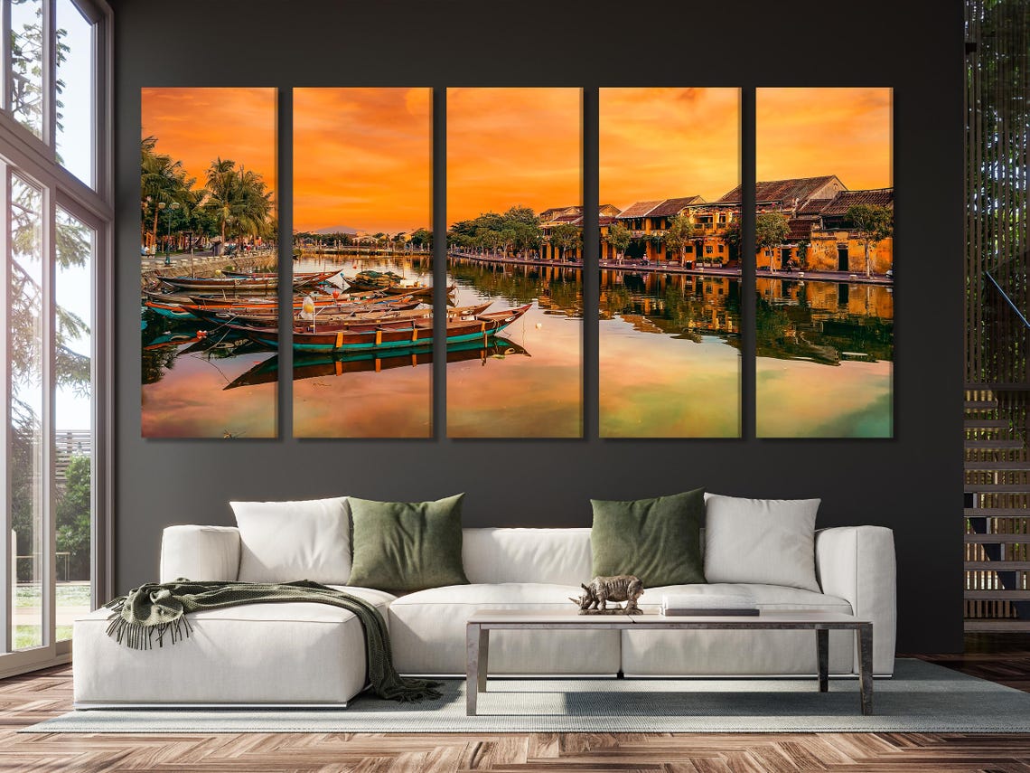 Dining room scene with a framed sunset river boats artwork on a wall