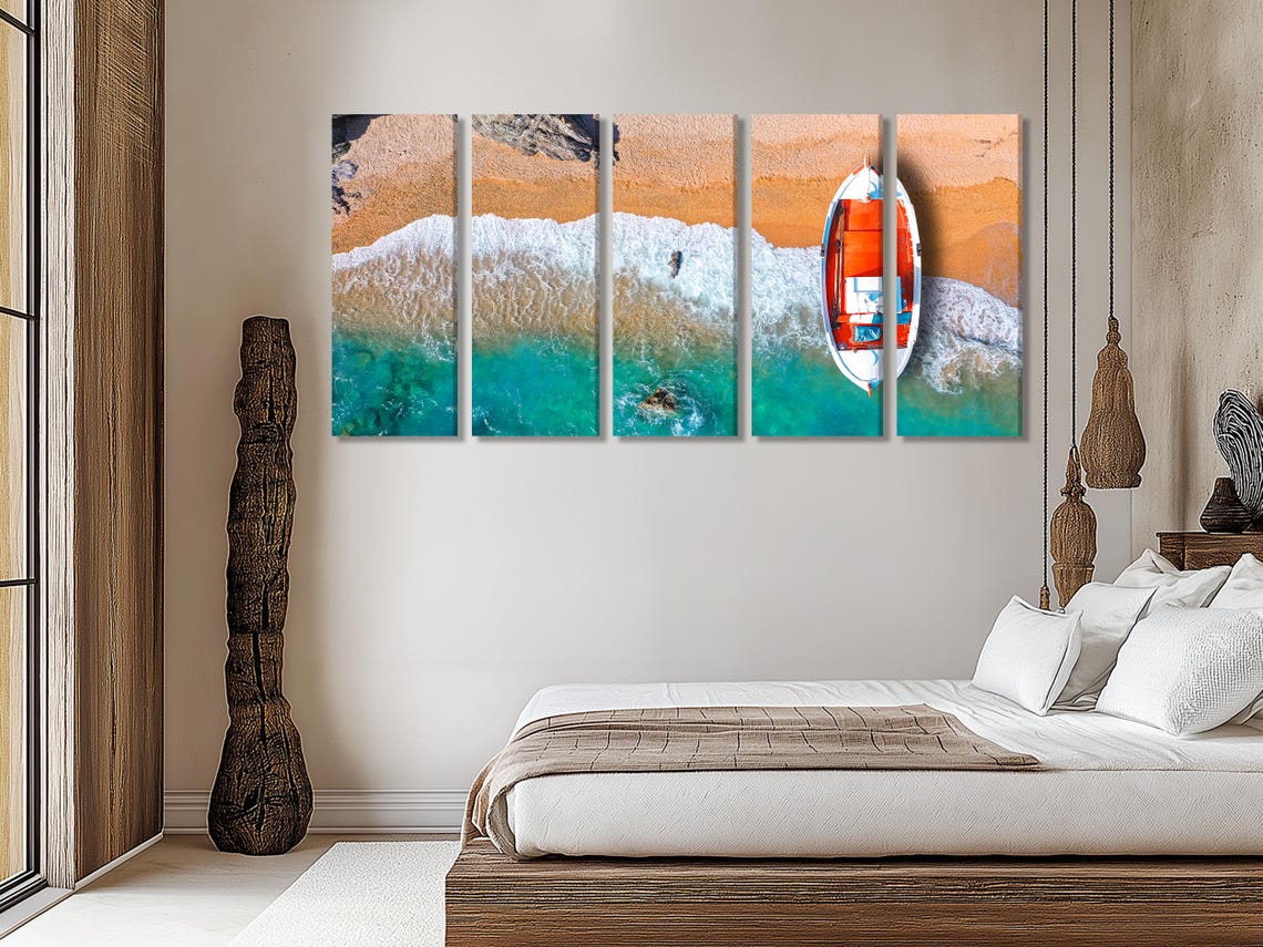 Room mockup showing three coastal panels with an orange fishing boat over turquoise water and foam
