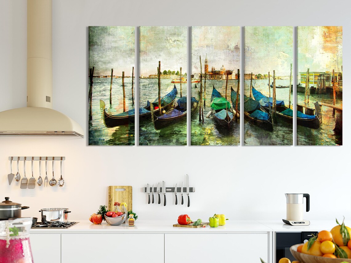 Colourful Venice gondolas moored at wooden posts with teal boat covers and rippled water reflections detail view