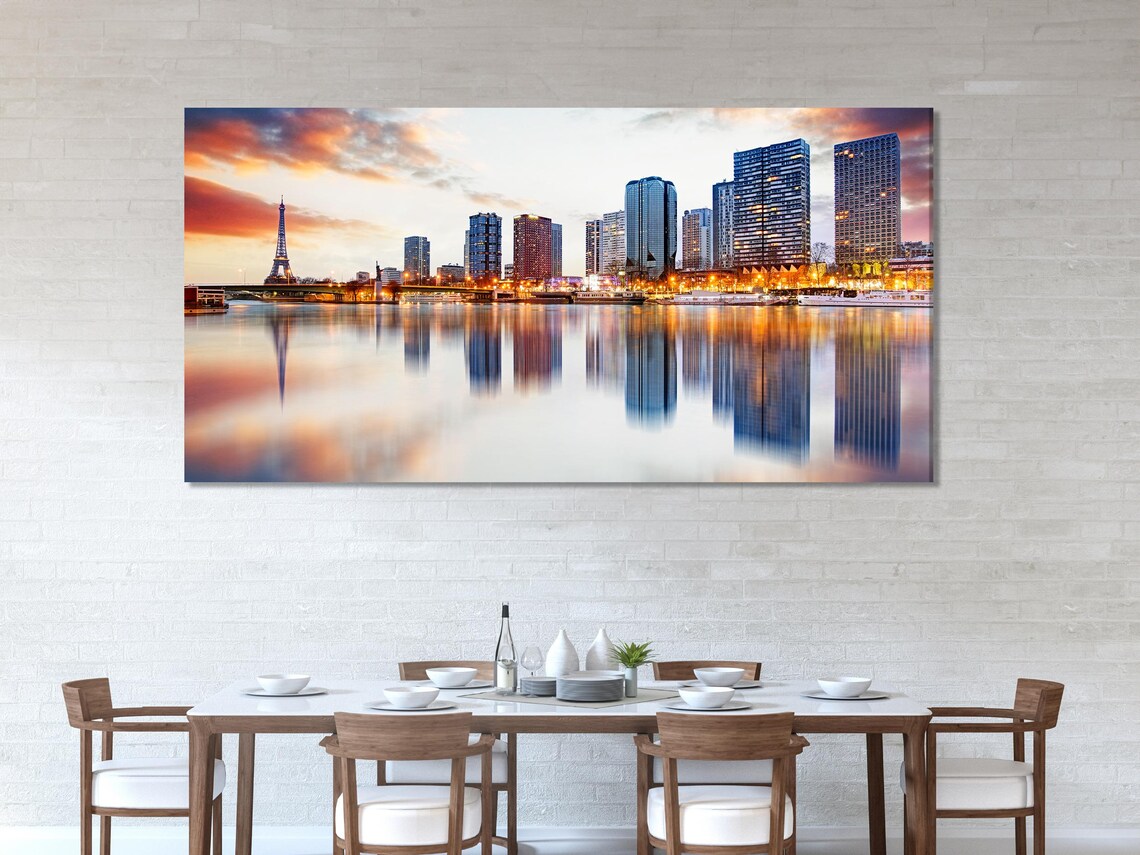 Room mockup showing three dusk city skyline panels above a dining table
