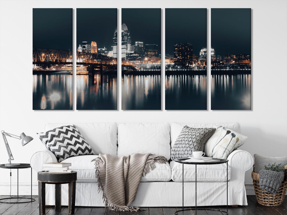 Modern dining room with three-panel night city skyline wall art above a table
