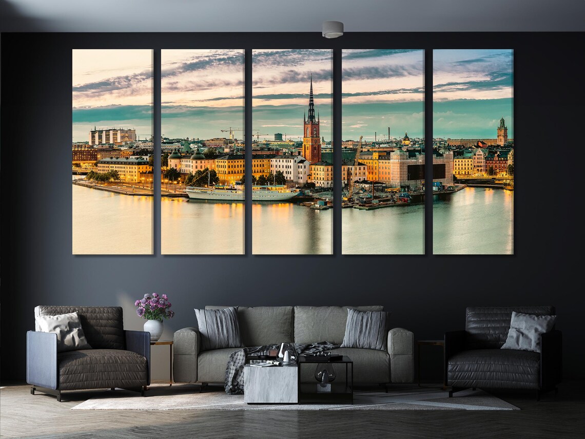Living room scene with a framed sunset cityscape artwork above a sofa